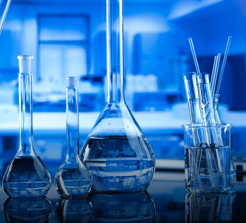 Laboratory glassware with blue liquid inside.